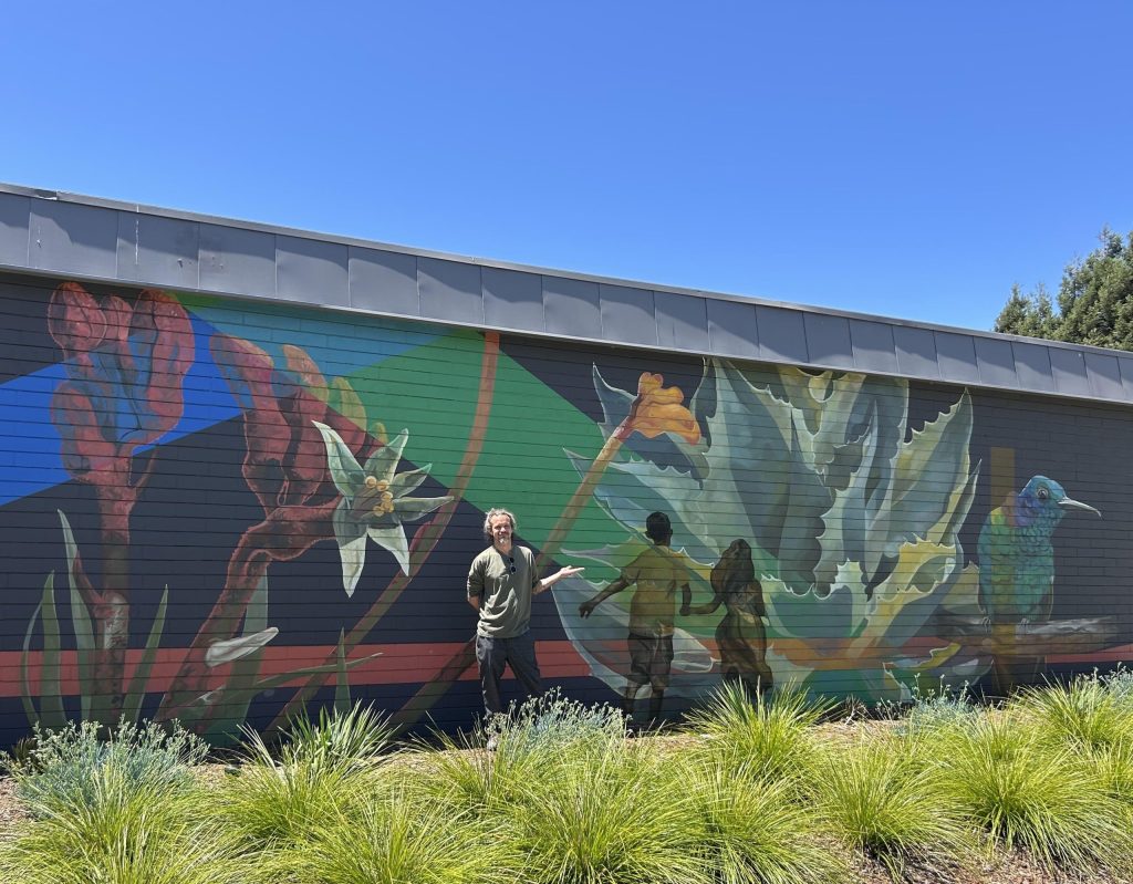 American Canyon artist Sebastien Pridmore in front of the mural he painted for the Napa Valley Community Foundation. Fiona Ulrich photo