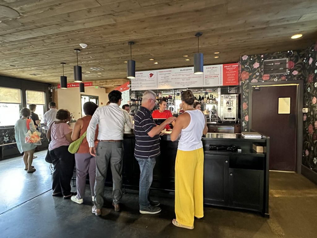 Patrons order before finding seats at Burgers & Half Bottles. Lisa Adams Walter photo