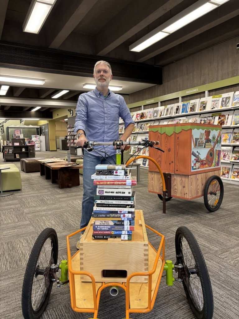 Anthony Halstead demonstrates banned books. Submitted photo