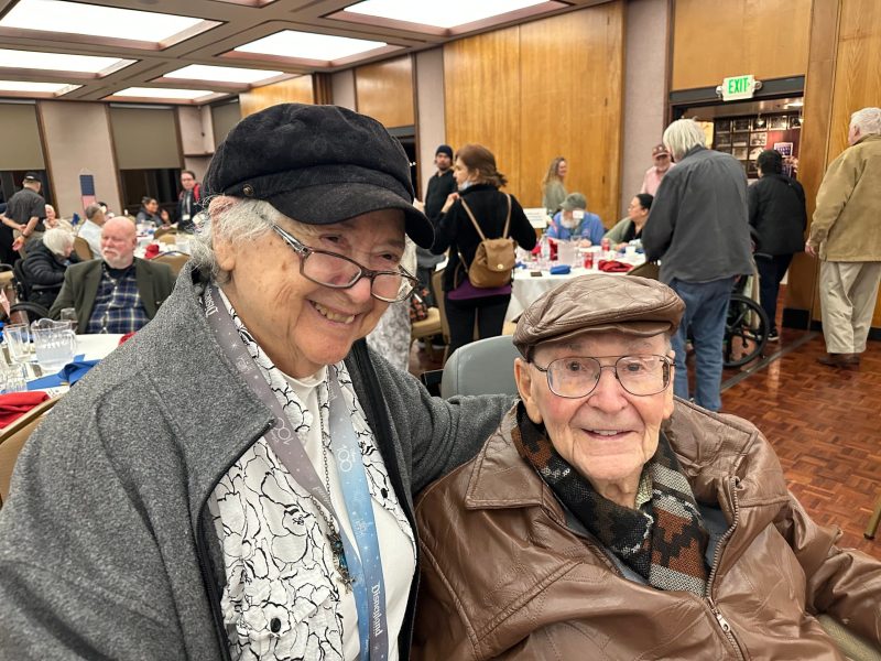 VIP World War II veteran attendee Bob Heiss (seated), 102, visited with his friend Barbara Meraz. Neighbors at the home since 2008. Lisa Adams Walter photo