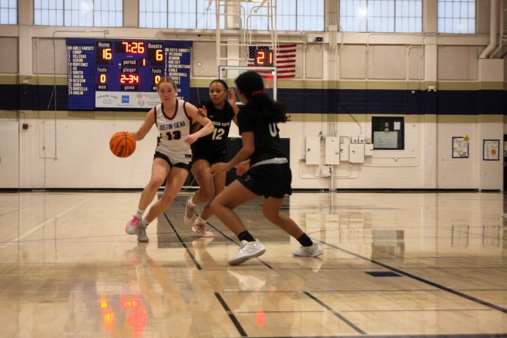 Justin-Siena's Dylan Zapolski dribbles through American Canyon girls basketball players. Kyle Foster photo