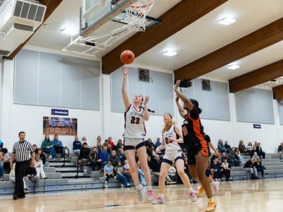 high schooler doing a layup on court