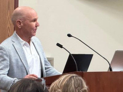 man standing at a podium talking