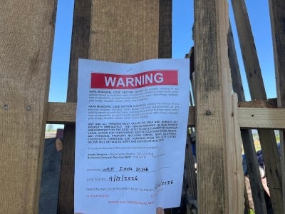 a paper stapled to a wooden plank