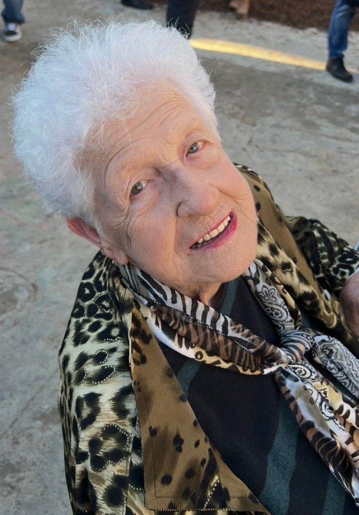 an older woman with white hair and leopard print